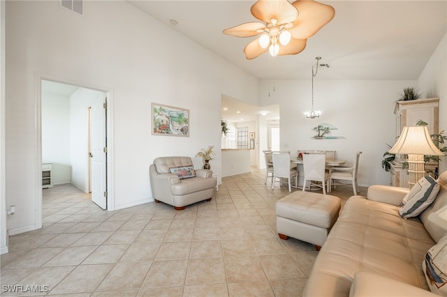 living area featuring light tile patterned flooring, visible vents, high vaulted ceiling, and a ceiling fan