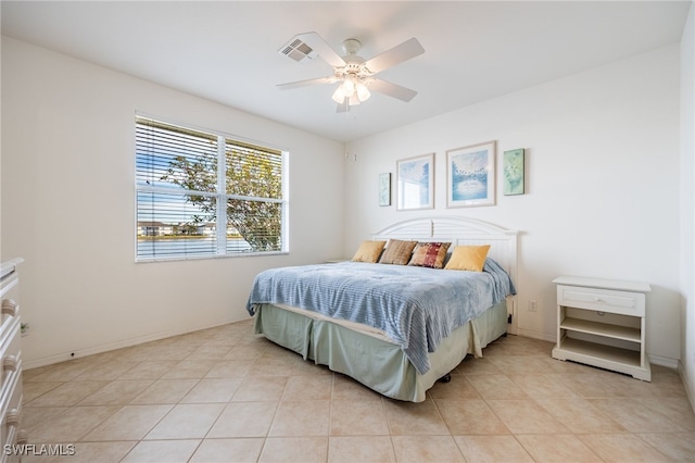 bedroom with light tile patterned floors, a ceiling fan, and baseboards