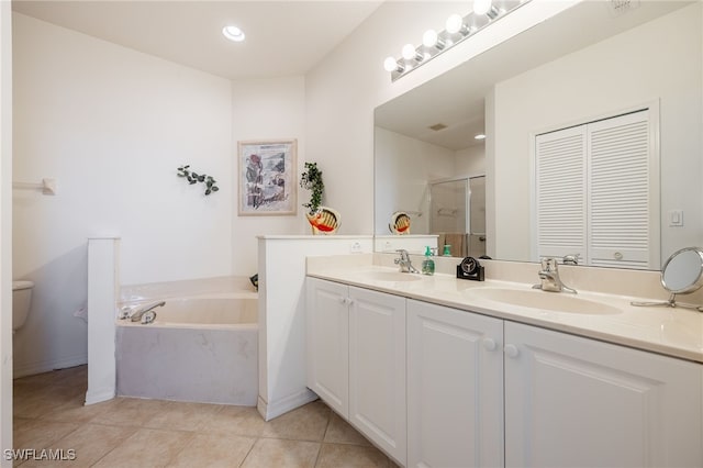 bathroom featuring a sink, a stall shower, double vanity, and tile patterned flooring