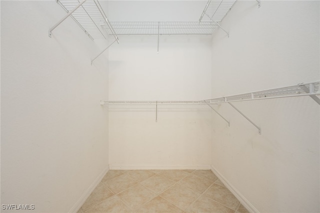 spacious closet featuring light tile patterned floors