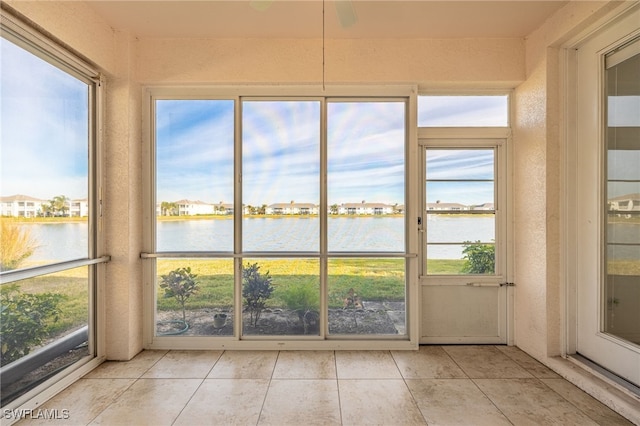 unfurnished sunroom featuring a water view