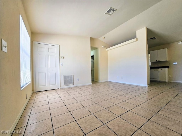 unfurnished living room with vaulted ceiling, light tile patterned floors, and visible vents