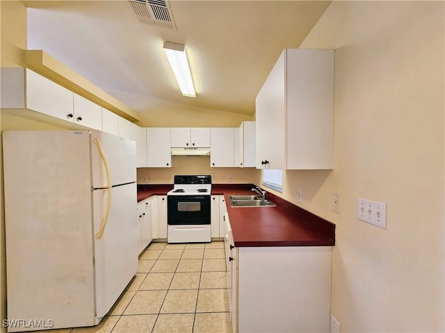 kitchen with dark countertops, under cabinet range hood, freestanding refrigerator, electric range, and a sink