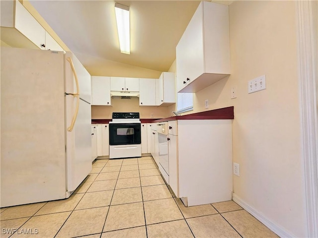 kitchen featuring dark countertops, vaulted ceiling, light tile patterned floors, white appliances, and white cabinetry