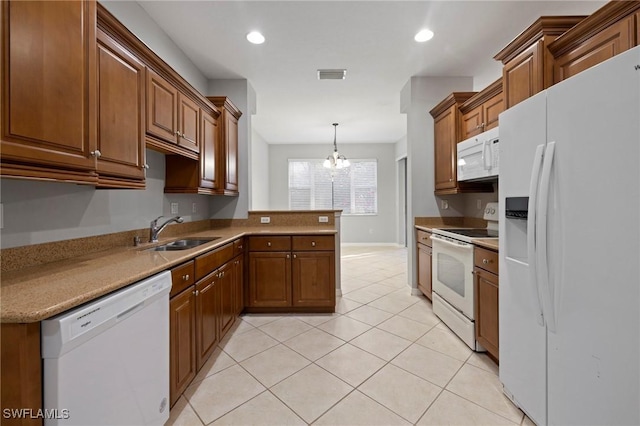 kitchen with visible vents, a sink, white appliances, a peninsula, and an inviting chandelier