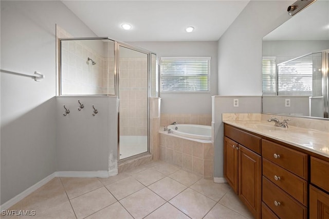 full bathroom featuring vanity, tile patterned floors, a garden tub, and a shower stall