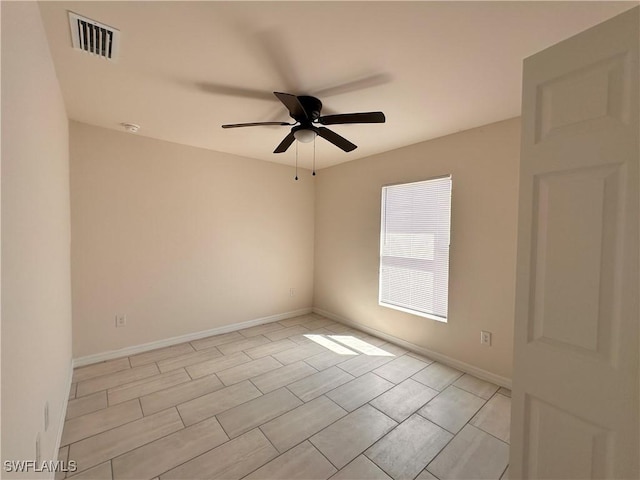 spare room featuring visible vents, baseboards, and ceiling fan