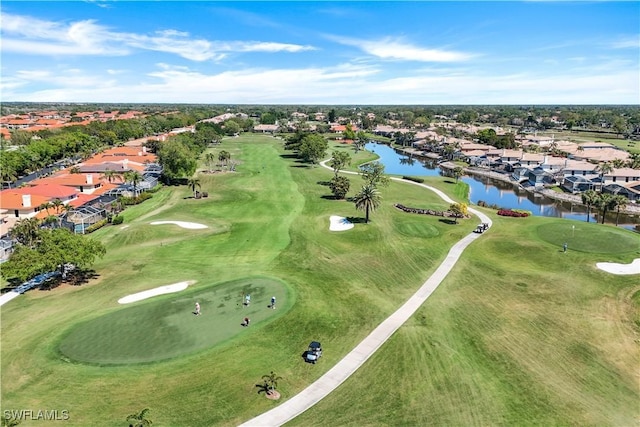 bird's eye view with view of golf course, a residential view, and a water view