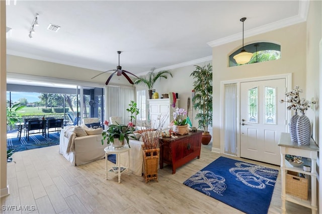 entryway with ceiling fan, light wood-style floors, visible vents, and plenty of natural light
