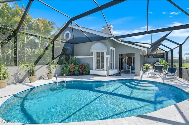 outdoor pool with a patio area and a lanai