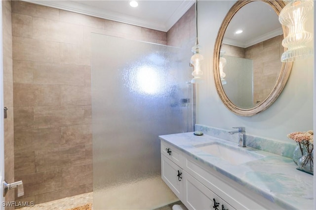 bathroom with ornamental molding, vanity, a walk in shower, and recessed lighting