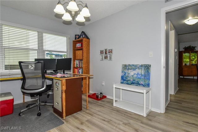6102 Augusta Dr Unit 209, Fort Myers, FL 33907 - office featuring light wood finished floors, baseboards, and an inviting chandelier