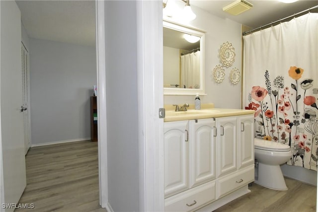 6102 Augusta Dr Unit 209, Fort Myers, FL 33907 - bathroom with vanity, toilet, wood finished floors, and visible vents