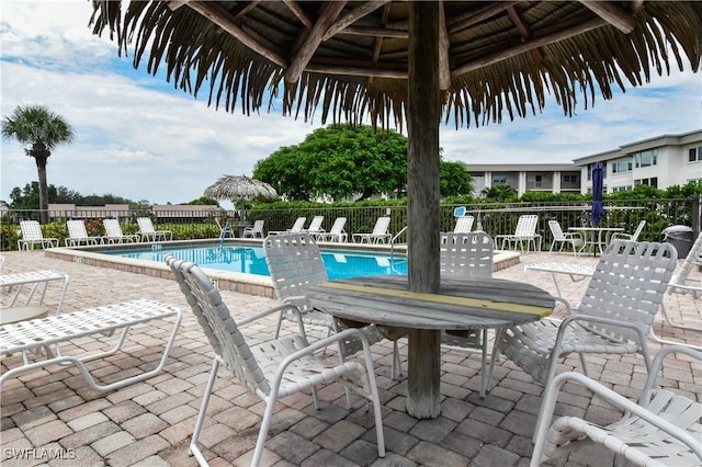 6102 Augusta Dr Unit 209, Fort Myers, FL 33907 - community pool featuring a patio area and fence