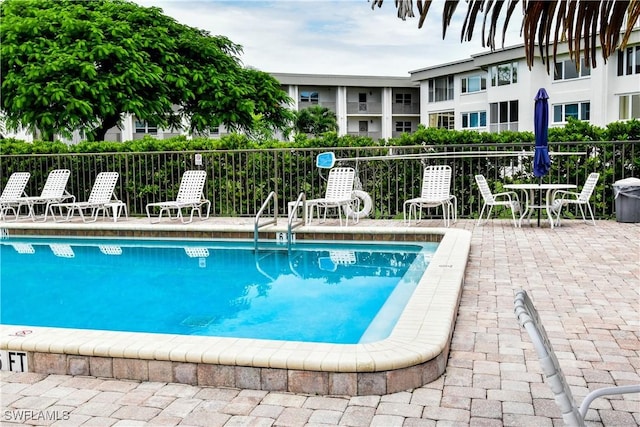 6102 Augusta Dr Unit 209, Fort Myers, FL 33907 - pool featuring a patio and fence