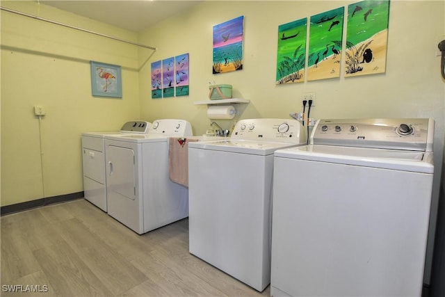 6102 Augusta Dr Unit 209, Fort Myers, FL 33907 - laundry room featuring laundry area, light wood finished floors, and washer and clothes dryer
