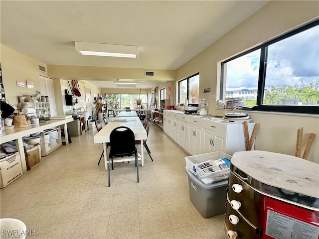 6102 Augusta Dr Unit 209, Fort Myers, FL 33907 - dining area with light floors and visible vents