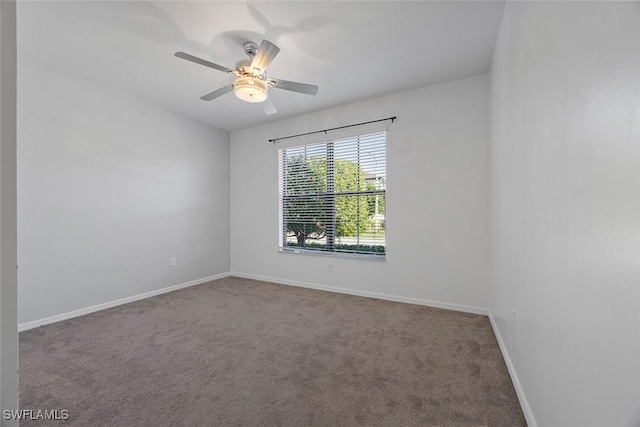 carpeted empty room with baseboards and ceiling fan