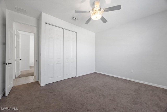 unfurnished bedroom featuring visible vents, ceiling fan, baseboards, carpet flooring, and a closet