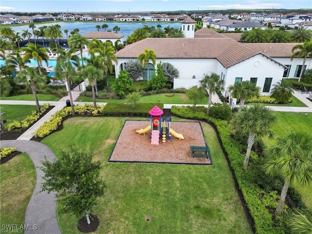 view of community featuring playground community, a residential view, and a lawn