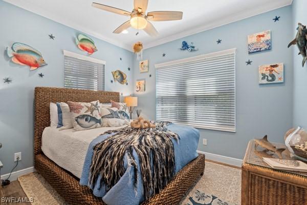 bedroom with a ceiling fan and baseboards