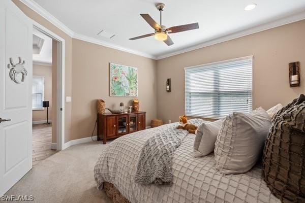 bedroom featuring baseboards, light colored carpet, ceiling fan, and crown molding