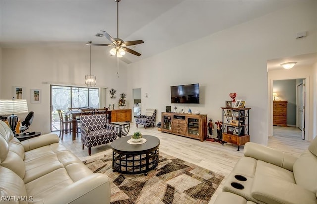 living room with light wood-style floors, ceiling fan, and high vaulted ceiling