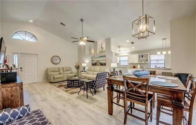 dining space featuring visible vents, plenty of natural light, ceiling fan with notable chandelier, and light wood-style floors