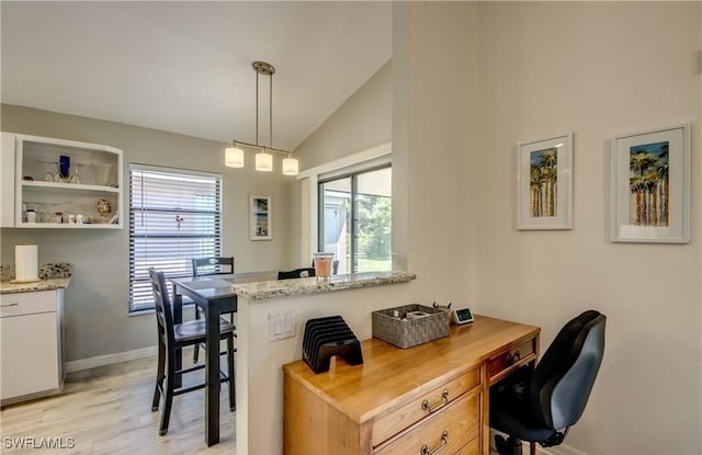 office area with lofted ceiling, baseboards, and light wood finished floors