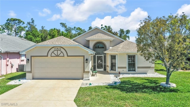 view of front of home featuring stucco siding, concrete driveway, a front yard, a shingled roof, and a garage