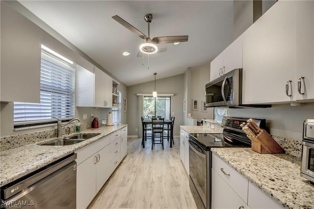 kitchen with a sink, a ceiling fan, white cabinetry, and stainless steel appliances