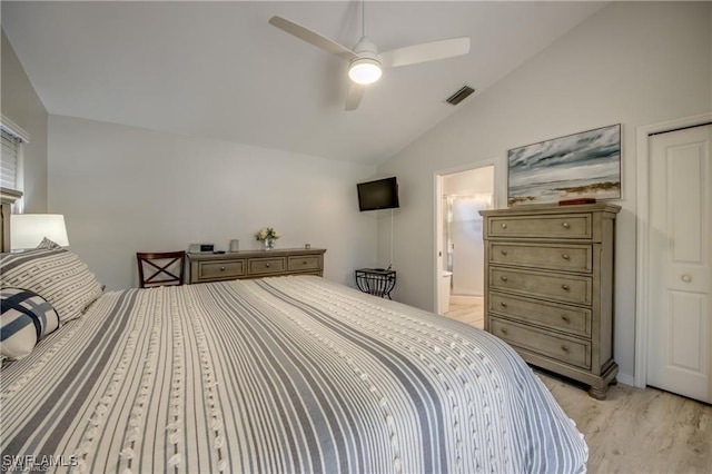 bedroom featuring visible vents, connected bathroom, light wood-style floors, ceiling fan, and vaulted ceiling