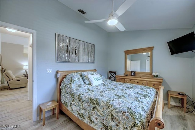 bedroom featuring visible vents, baseboards, vaulted ceiling, light wood-style flooring, and a ceiling fan