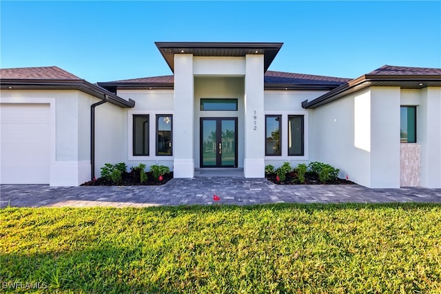 1912 SW 12th St, Cape Coral, FL 33991 - entrance to property featuring stucco siding, a yard, and french doors