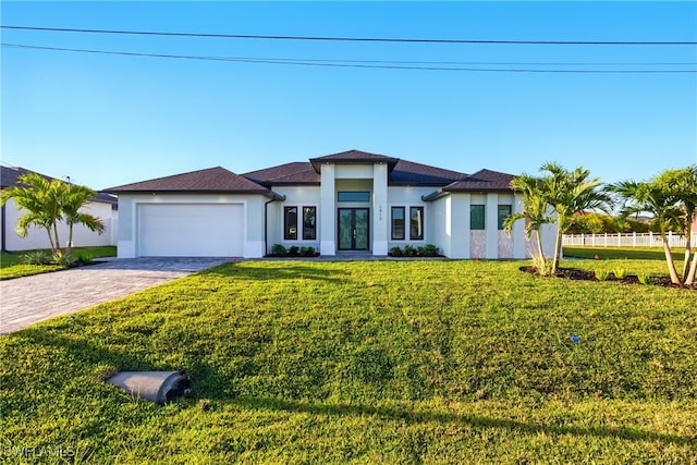 1912 SW 12th St, Cape Coral, FL 33991 - view of front of home with decorative driveway, a front yard, an attached garage, and stucco siding