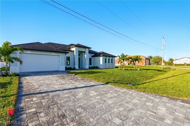 1912 SW 12th St, Cape Coral, FL 33991 - prairie-style house with decorative driveway, a garage, a front yard, and stucco siding