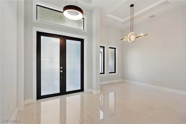 1912 SW 12th St, Cape Coral, FL 33991 - entryway featuring a chandelier, french doors, a raised ceiling, and baseboards