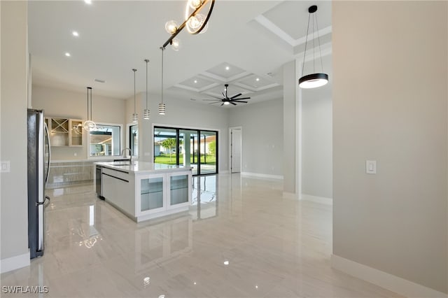 1912 SW 12th St, Cape Coral, FL 33991 - kitchen with marble finish floor, coffered ceiling, appliances with stainless steel finishes, baseboards, and a large island with sink