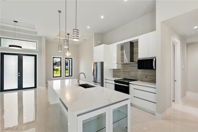 1912 SW 12th St, Cape Coral, FL 33991 - kitchen featuring a sink, stainless steel appliances, white cabinetry, wall chimney exhaust hood, and modern cabinets