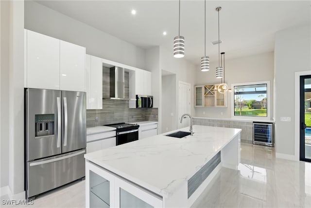 1912 SW 12th St, Cape Coral, FL 33991 - kitchen featuring a sink, wine cooler, appliances with stainless steel finishes, wall chimney range hood, and modern cabinets