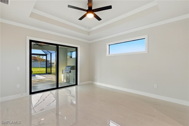 1912 SW 12th St, Cape Coral, FL 33991 - empty room featuring a wealth of natural light, a raised ceiling, and baseboards