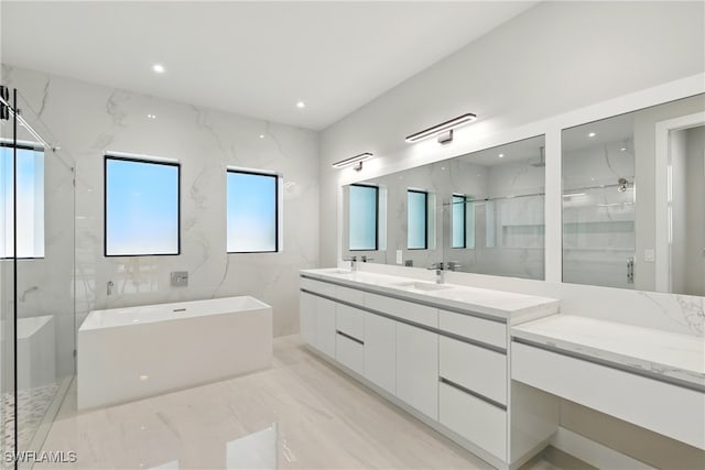 1912 SW 12th St, Cape Coral, FL 33991 - bathroom with a marble finish shower, a soaking tub, double vanity, and a sink