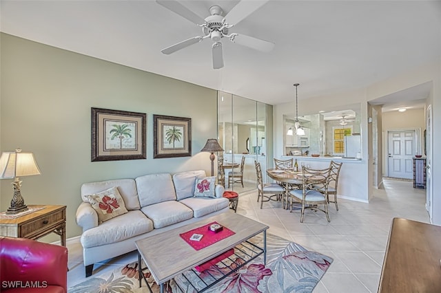 living room with light tile patterned floors, baseboards, and ceiling fan