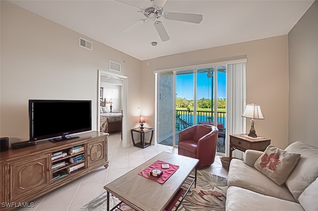 living area with light tile patterned floors, visible vents, and a ceiling fan