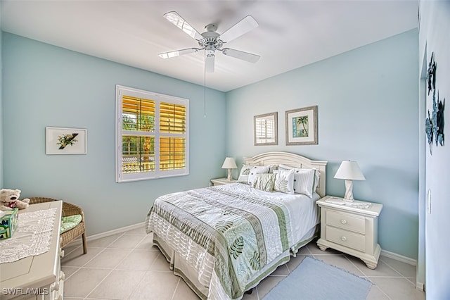 bedroom with light tile patterned floors, ceiling fan, and baseboards