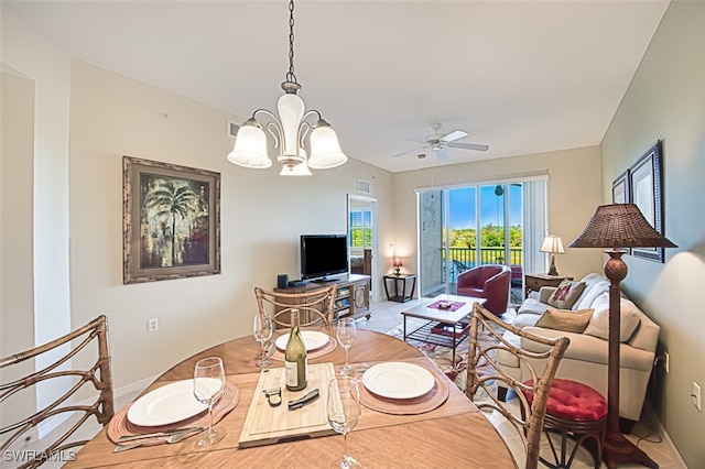 living area featuring ceiling fan with notable chandelier