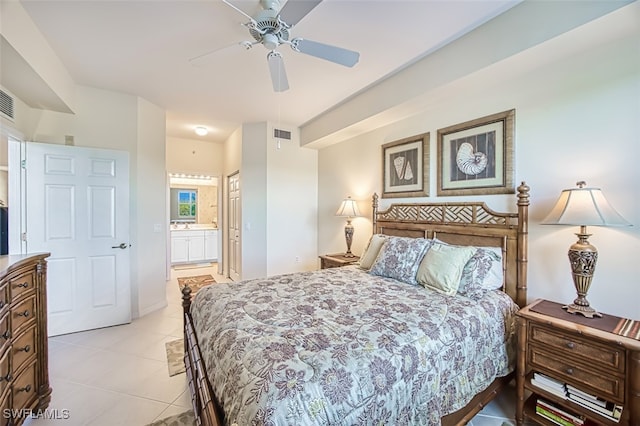 bedroom featuring light tile patterned floors, visible vents, ensuite bath, and a ceiling fan