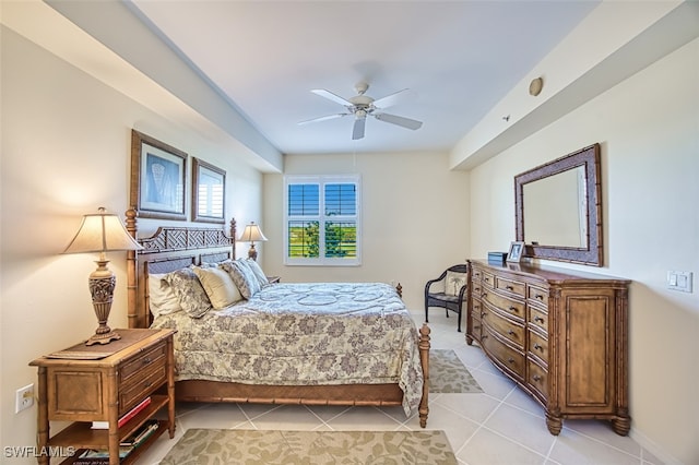 bedroom featuring light tile patterned floors, baseboards, and ceiling fan