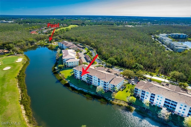 birds eye view of property featuring a wooded view and a water view