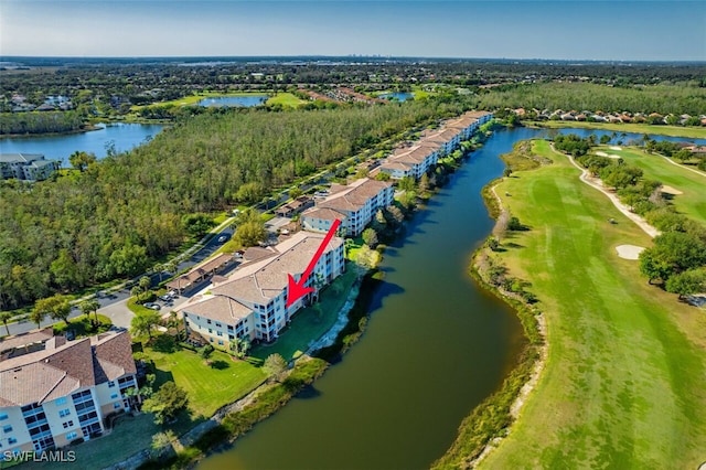 birds eye view of property with a view of trees and a water view